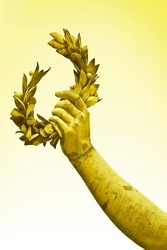 Hand Holds A Laurel Wreath - Bronze Statue On Golden Background - Success And Fame Concept Image