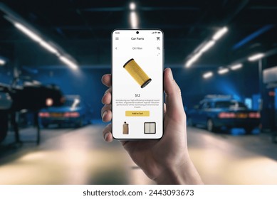 Hand holds a mobile phone with car parts. Purchasing an oil filter for car service at a garage through mobile commerce - Powered by Shutterstock