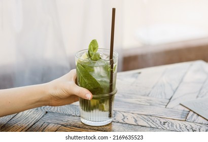  Hand Holds A Mojito With Ice. Non-alcoholic Summer Cocktails. Refresh Yourself