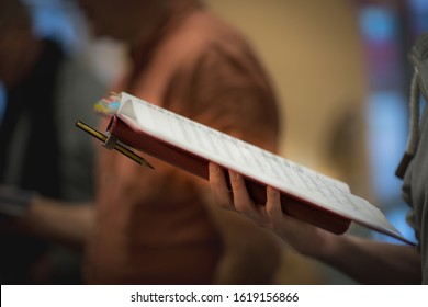 Hand Holds Notes During Choir Rehearsal, Shallow Depth Of Field