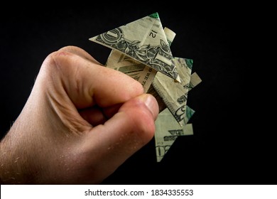 Hand Holds Origami Paper Money House For Real Estate And Housing Market Concept