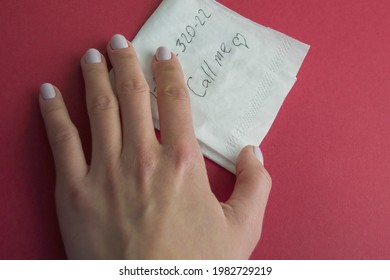 Hand Holds A Paper Napkin With A Written Phone Number And Text - Call Me