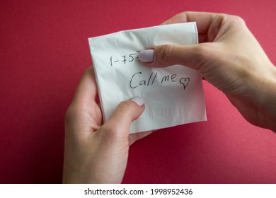 Hand Holds A Paper Napkin With A Written Phone Number And Text - Call Me