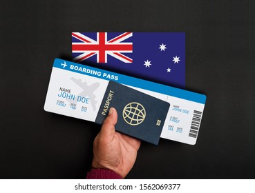 Hand Holds Passport And Boarding Pass With Flag Of Australia