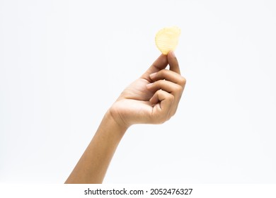 
Hand holds potato chips. Isolated on a white background.