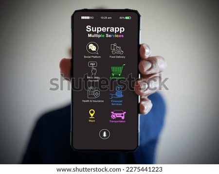 Hand holds a smartphone with a super app for mobile phones that serves multiple services as a one-stop service.