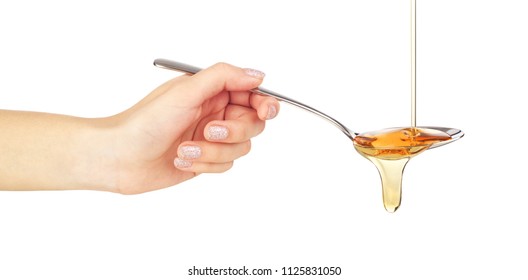 Hand Holds A Spoon With Syrup