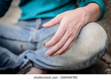 Hand of homeless beggar asks for alms, help, money and food on concrete. Beggar begging on the street. Poverty concept. Unemployed human in torn clothes sitting on the ground. - Powered by Shutterstock