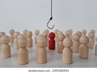 Hand with hook pulls red human figure out of crowd. Reveal disloyalty, repression and dissent