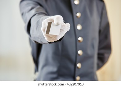 Hand Of Hotel Clerk Offering A Key Card