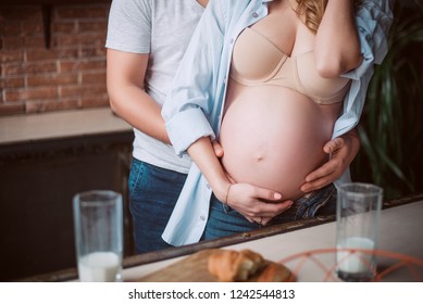 Hand hug the pregnant tummy. Morning pregnant on the kitchen - Powered by Shutterstock