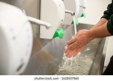 Hand Hygiene and Food Safety. Factory worker washing hands. coronavirus protection - Powered by Shutterstock