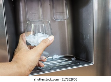 Hand With Ice Dispenser And Glass