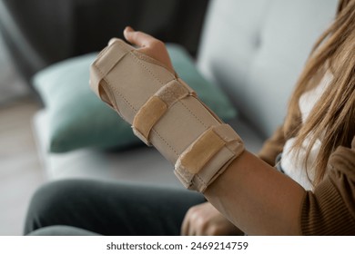 Hand injury. Broken wrist and arm with bandage or immobilizer. woman uses hand splints. Inflammation. Copy space - Powered by Shutterstock