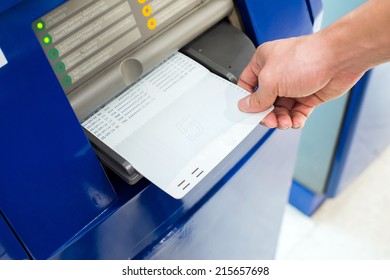 Hand Inserting Account Bankbook Into Automatic Passbook Update Machine