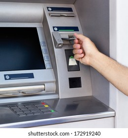 Hand inserting card into cash machine  - Shutterstock ID 172919240
