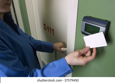 A Hand Inserting Keycard In The Electronic Lock