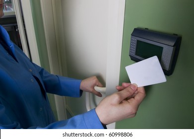 A Hand Inserting Keycard In The Electronic Lock