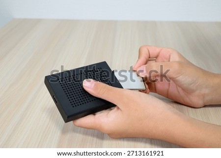 Hand Inserting Memory Card into Card Reader