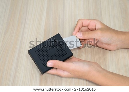Hand Inserting Memory Card into a Card Reader