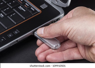 Hand Inserting Usb Thumb Drive Into Computer