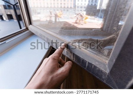 Hand Inspecting Window Seal At Frame Edge, Fingertip Pressure And Careful Check Of Fit And Gap, Scene Conveys Maintenance Action, Workmanship And Property Care In Interior Setting.