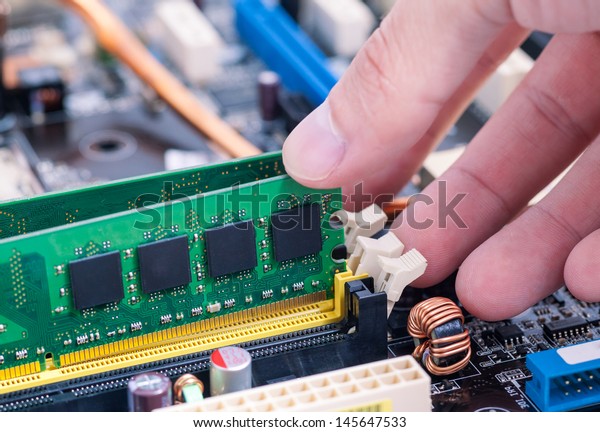 Hand\
Installing a SDRAM Module on PC\
Mainboard.