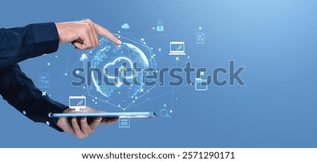 Hand interacting with cloud storage icons on a digital tablet, global network symbols, blue background, representing storage service