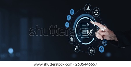 Hand interacting with digital interface showing legal and compliance icons on dark background. Concept of business regulations and legal technology