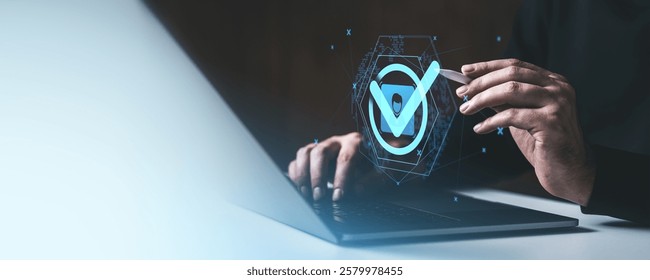 Hand interacting with a glowing checkmark hologram above a laptop, symbolizing validation on a gradient background. Concept of digital security