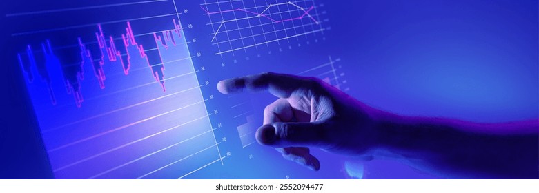 Hand interacting with glowing digital financial charts in blue futuristic interface. Data visualization, finance, and market analysis. Concept of business, analytics, technology. Banner