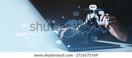 Hand interacting with rising forex chart and investment graph in futuristic hologram style over a laptop, symbolizing stock market trading and strategy