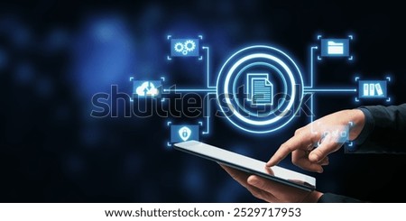 A hand interacting with a tablet displaying digital file management icons on a dark background, showcasing technology concepts