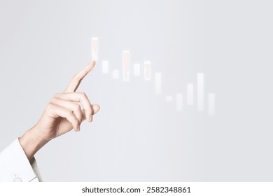 A hand interacts with a digital chart, pointing at data. The hand gestures towards a virtual graph, engaging with digital data and chart elements.