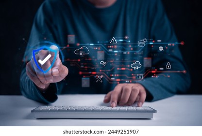 A hand interacts with digital cybersecurity elements over a keyboard, cloud cybersecurity and protection hacker data network digital technology information online.
