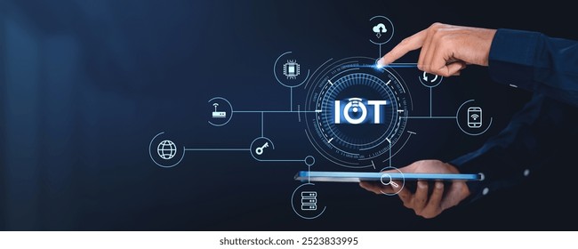 A hand interacts with a digital interface representing IoT connections and devices, on a dark background. Concept of global connectivity and technology