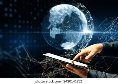 A hand interacts with a futuristic hologram of the Earth projected above a tablet, signifying global connectivity and advanced technology