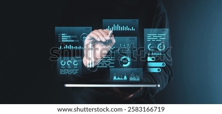 A hand interacts with glowing holographic data graphs and charts, showcasing futuristic digital visualization on a dark background. Concept of innovation