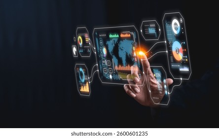A hand interacts with a holographic display showing data visualizations, world maps, and charts, highlighting technology and digital interfaces.