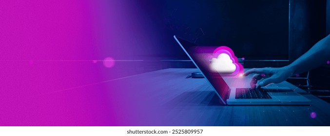 hand interacts with a laptop keyboard while a glowing cloud icon hovers above the screen. The vibrant neon colors and modern design represent cloud computing, data storage, and online connection.