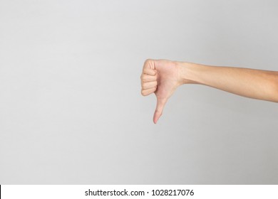 Hand Isolated On Light White Background, Copy Space. Hand Shows Thumbs Down Sign.Body Language Concept. 