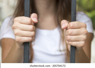 hand in jail, behind bars 