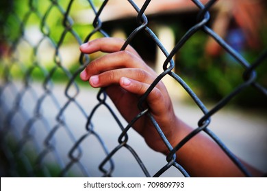 Hand in jail with girl and house of detention concept, vignette effect and selective focus. - Shutterstock ID 709809793