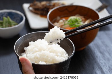 Hand of a Japanese woman eating dinner