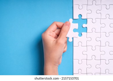 hand jigsaw puzzle pattern missing piece White jigsaw puzzle pattern top view to express alliance union team working solution success problem. Business assemble metaphor or puzzles game challenge. - Powered by Shutterstock