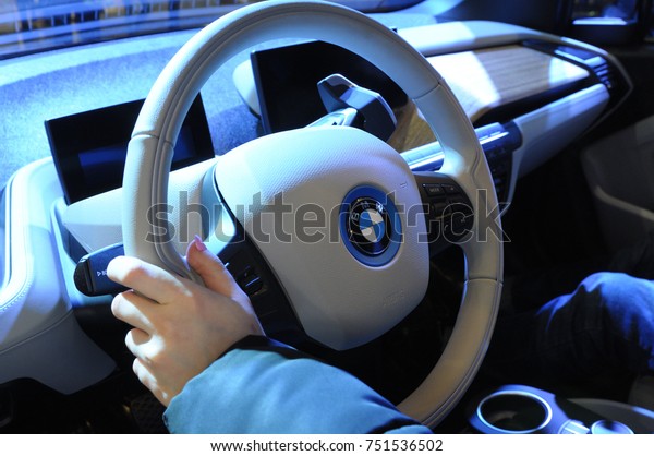 Hand keeping steering wheel of electric car\
“BMW i3”. Exhibition ECO DRIVE 2017. March 10, 2017. International\
Expo center, Kiev,\
Ukraine\
