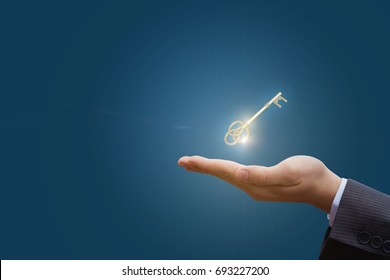 In hand the key to success in business on a blue background.