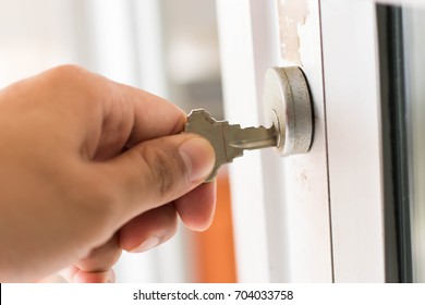Hand and key Unlock the door.