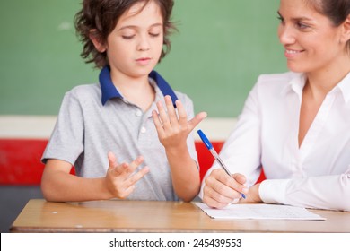 Hand Of Kid Learning Math With Teacher.