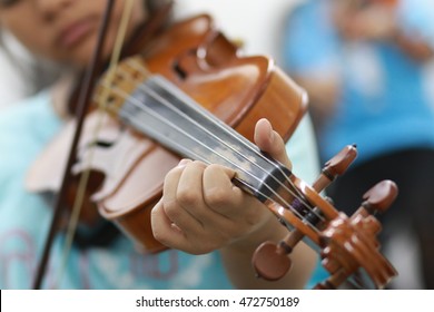  Hand Of Kid On The Strings Of A Violin